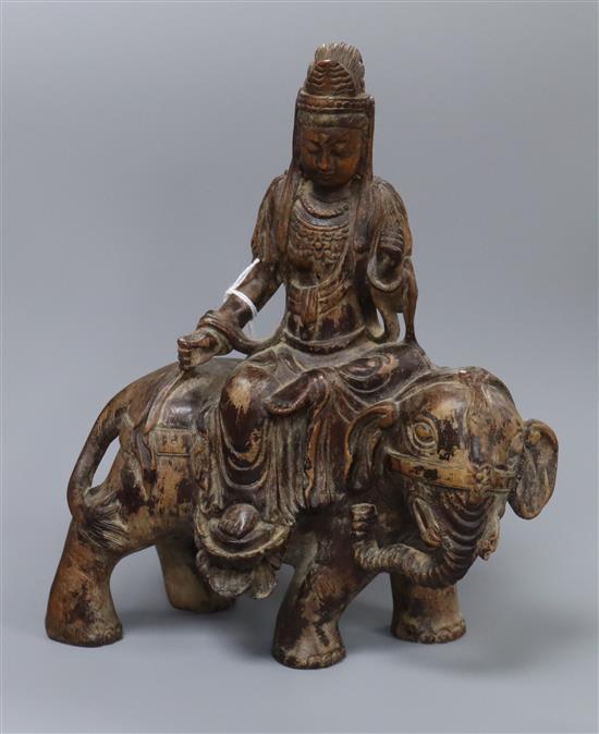 A Chinese wood carving of Guanyin on elephant, Qing height 24cm